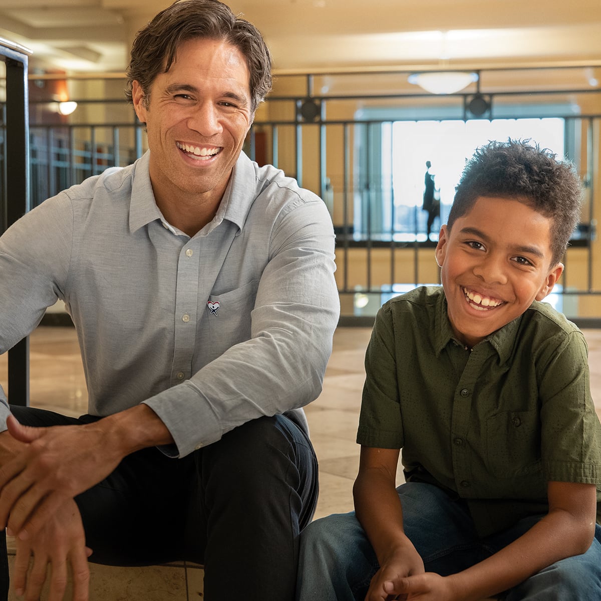 Adult and child sit together at courthouse